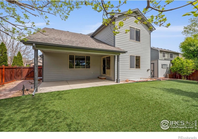 2476 Forsythia Dr, Loveland, CO 80537 - rear view of property featuring a lawn, a fenced backyard, roof with shingles, and a patio area