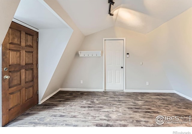 387 Millionaire Dr E, Boulder, CO 80302 - additional living space featuring wood finished floors, vaulted ceiling, and baseboards
