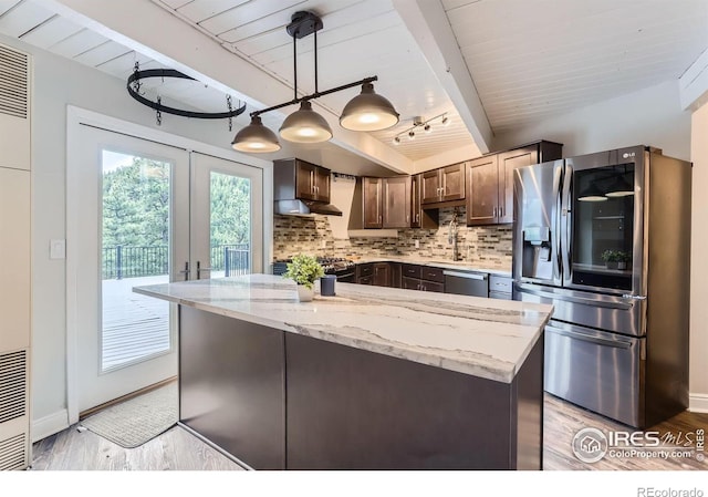 387 Millionaire Dr E, Boulder, CO 80302 - kitchen with appliances with stainless steel finishes, light stone counters, tasteful backsplash, beamed ceiling, and light wood finished floors