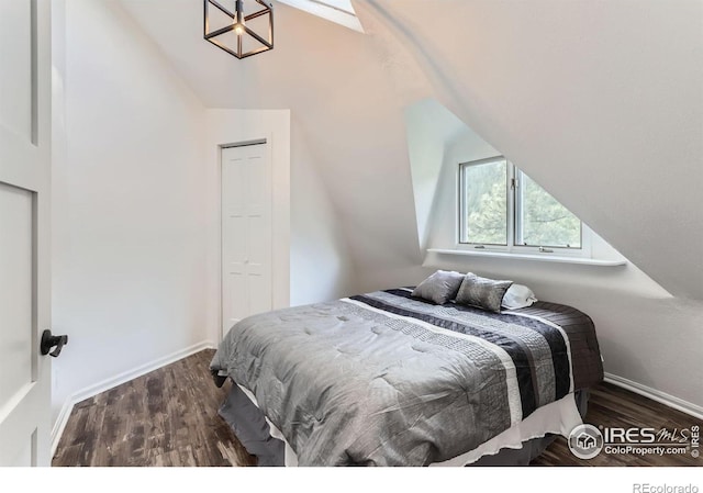 387 Millionaire Dr E, Boulder, CO 80302 - bedroom featuring vaulted ceiling, wood finished floors, and baseboards