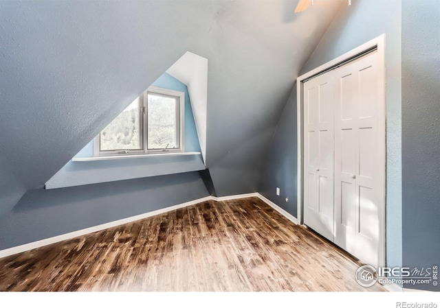 387 Millionaire Dr E, Boulder, CO 80302 - bonus room with vaulted ceiling, wood finished floors, and baseboards