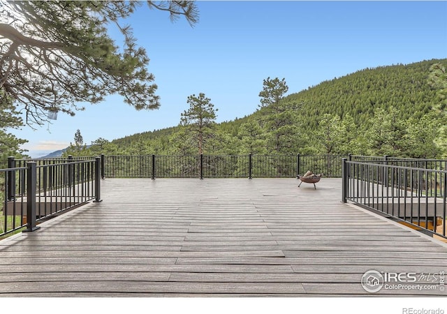 387 Millionaire Dr E, Boulder, CO 80302 - wooden terrace with a wooded view