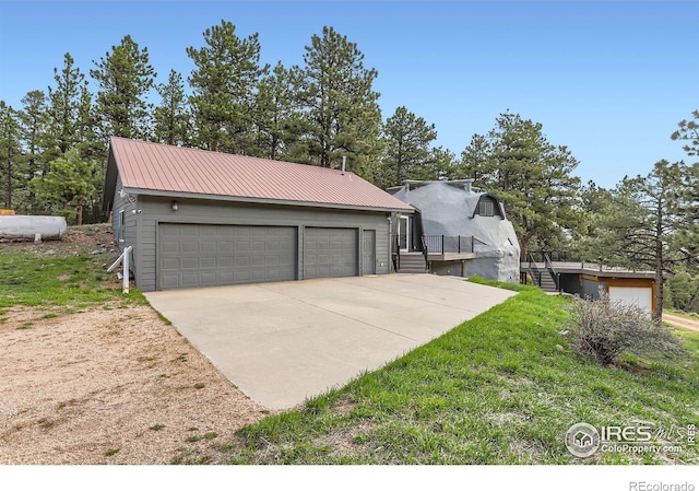 387 Millionaire Dr E, Boulder, CO 80302 - view of front facade with a detached garage and metal roof