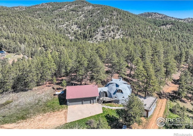 387 Millionaire Dr E, Boulder, CO 80302 - view from above of property with a heavily wooded area and mountains