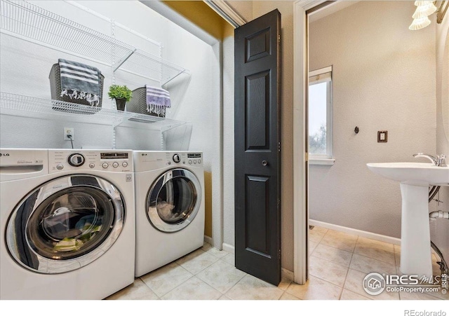 8355 Louden Circle Ft, Collins, CO 80528 - washroom featuring light tile patterned floors, baseboards, laundry area, and washing machine and dryer