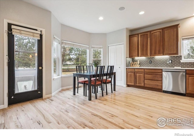 8355 Louden Circle Ft, Collins, CO 80528 - kitchen featuring brown cabinetry, light wood finished floors, dishwasher, and tasteful backsplash