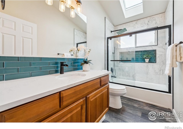 8355 Louden Circle Ft, Collins, CO 80528 - bathroom with vaulted ceiling with skylight, wood finished floors, vanity, toilet, and enclosed tub / shower combo