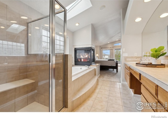 8355 Louden Circle Ft, Collins, CO 80528 - ensuite bathroom featuring tile patterned floors, a tiled fireplace, lofted ceiling, a bath, and a stall shower