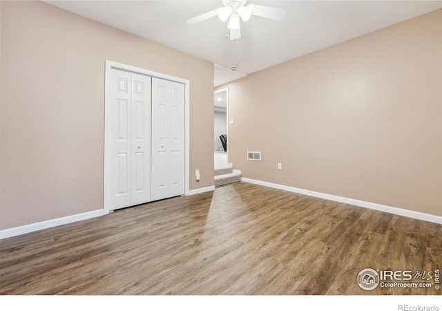 8355 Louden Circle Ft, Collins, CO 80528 - unfurnished bedroom featuring baseboards, a closet, wood finished floors, and visible vents