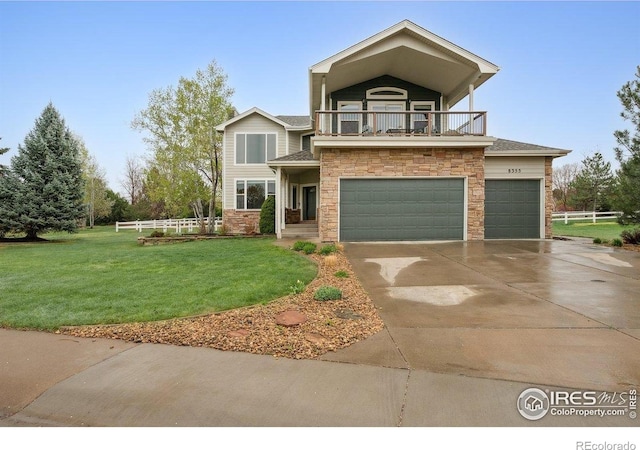 8355 Louden Circle Ft, Collins, CO 80528 - view of front of home with fence, a balcony, a front yard, stone siding, and driveway