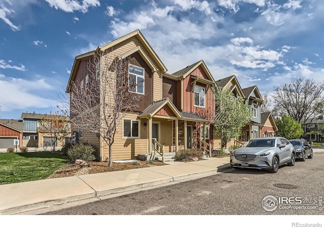 1320 Kestrel Ln Unit E, Longmont, CO 80501 - view of front of home featuring board and batten siding and a standing seam roof