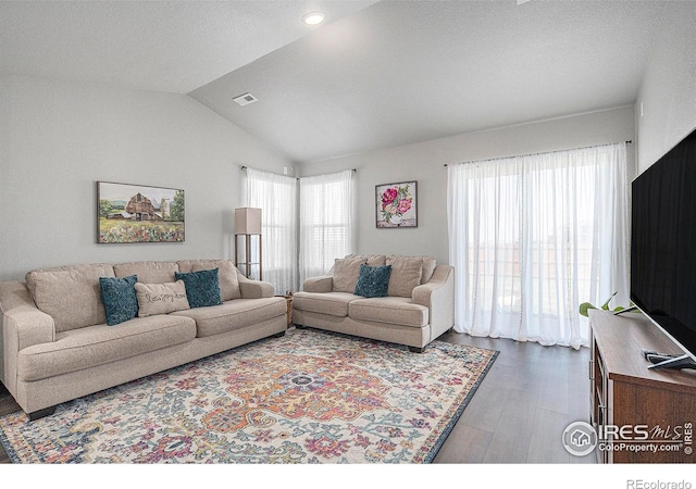 403 11th Ave, Wiggins, CO 80654 - living room featuring visible vents, recessed lighting, lofted ceiling, and wood finished floors