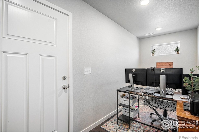 403 11th Ave, Wiggins, CO 80654 - office area with a textured ceiling, recessed lighting, baseboards, wood finished floors, and visible vents