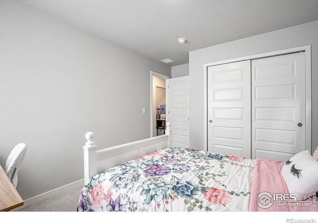 403 11th Ave, Wiggins, CO 80654 - bedroom featuring carpet floors, baseboards, and a closet