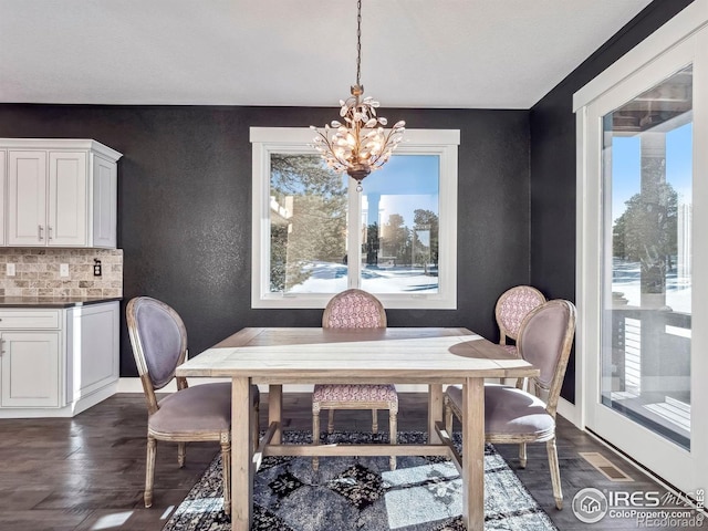 dining space featuring a healthy amount of sunlight, visible vents, and a chandelier