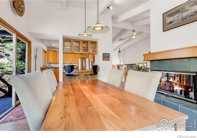 2345 Point Of Pines Dr, Boulder, CO 80302 - dining area featuring a tiled fireplace, high vaulted ceiling, ceiling fan, and beam ceiling