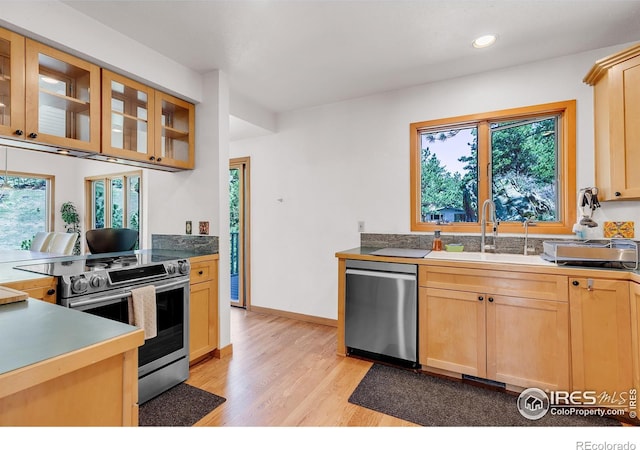 2345 Point Of Pines Dr, Boulder, CO 80302 - kitchen with appliances with stainless steel finishes, light brown cabinetry, a sink, glass insert cabinets, and light wood-style flooring