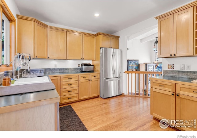 2345 Point Of Pines Dr, Boulder, CO 80302 - kitchen featuring a sink, light brown cabinets, light wood-style floors, freestanding refrigerator, and recessed lighting