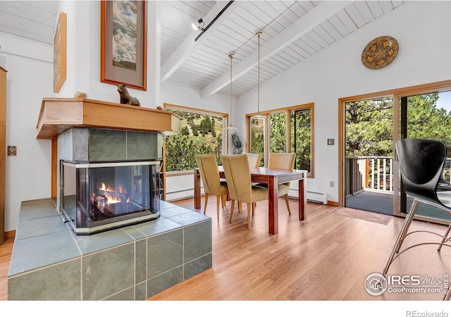 2345 Point Of Pines Dr, Boulder, CO 80302 - dining area featuring a baseboard radiator, wood finished floors, beam ceiling, and wooden ceiling