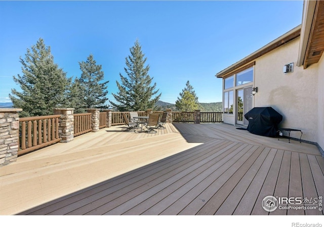 27921 Alabraska Ln, Evergreen, CO 80439 - deck with outdoor dining area, area for grilling, and a mountain view