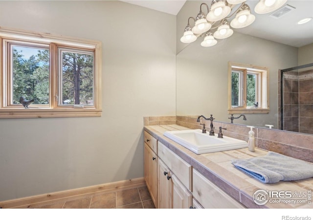 27921 Alabraska Ln, Evergreen, CO 80439 - full bath featuring healthy amount of natural light, vanity, and a chandelier