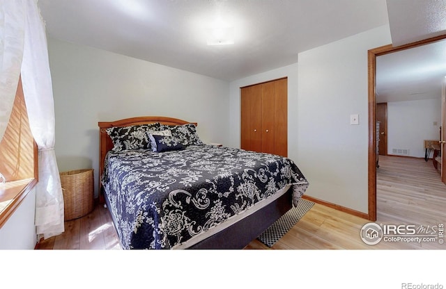 729 Jay Pl, Berthoud, CO 80513 - bedroom with light wood-style floors, a closet, and visible vents