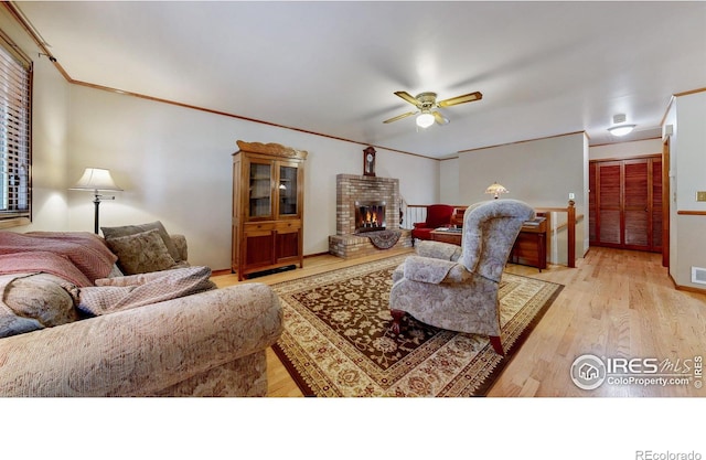 729 Jay Pl, Berthoud, CO 80513 - living area with a brick fireplace, ceiling fan, visible vents, and light wood finished floors