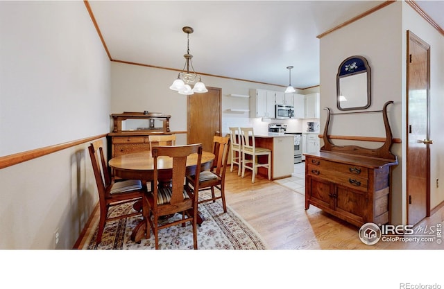 729 Jay Pl, Berthoud, CO 80513 - dining space featuring crown molding and light wood-style flooring