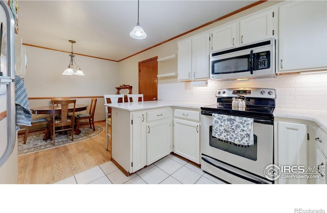 729 Jay Pl, Berthoud, CO 80513 - kitchen with crown molding, a peninsula, light countertops, appliances with stainless steel finishes, and backsplash