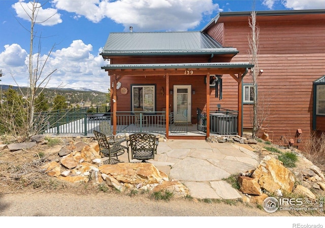 139 Ponderosa Dr, Nederland, CO 80466 - back of property featuring metal roof, central AC, and a patio area