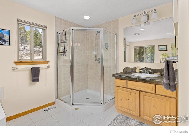 139 Ponderosa Dr, Nederland, CO 80466 - full bathroom featuring healthy amount of natural light, tile patterned floors, a stall shower, and vanity