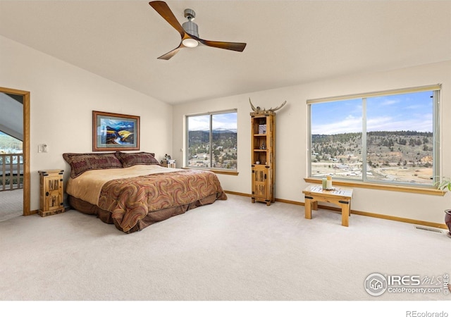 139 Ponderosa Dr, Nederland, CO 80466 - carpeted bedroom featuring multiple windows, lofted ceiling, baseboards, and ceiling fan