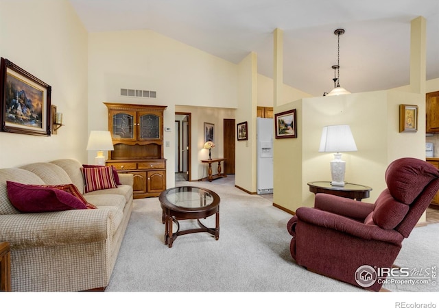 3500 Carlton Ave Unit 34, Fort Collins, CO 80525 - living area with light carpet, visible vents, and high vaulted ceiling