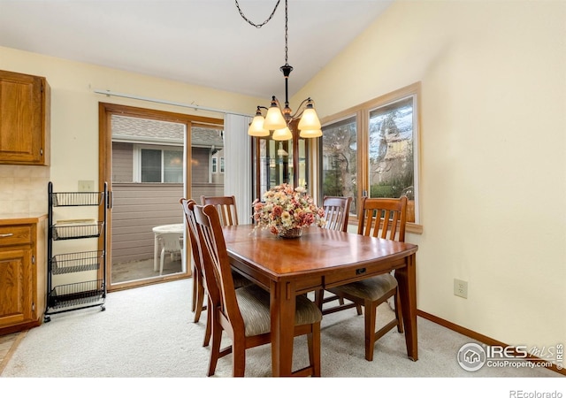 3500 Carlton Ave Unit 34, Fort Collins, CO 80525 - dining room featuring light colored carpet, an inviting chandelier, baseboards, and lofted ceiling
