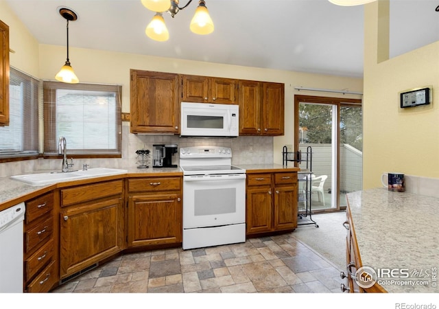3500 Carlton Ave Unit 34, Fort Collins, CO 80525 - kitchen featuring backsplash, light countertops, a sink, and white appliances