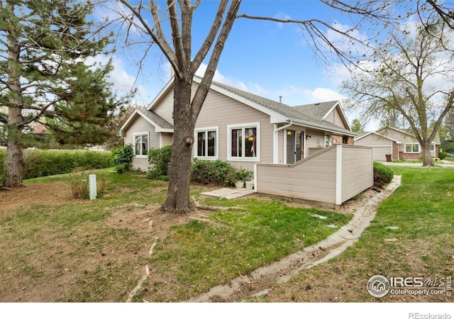 3500 Carlton Ave Unit 34, Fort Collins, CO 80525 - exterior space featuring a yard and roof with shingles