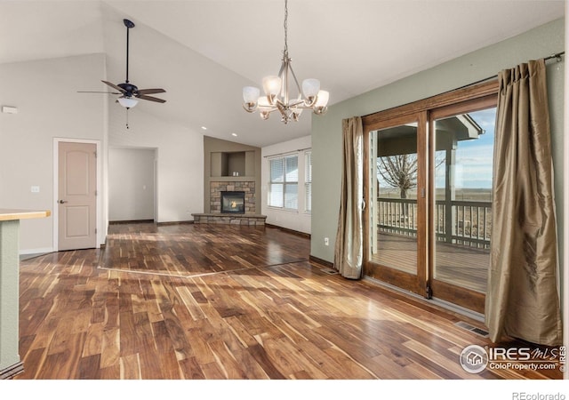7548 County Road 100, Wellington, CO 80549 - unfurnished living room featuring wood-type flooring, ceiling fan, baseboards, a chandelier, and a stone fireplace