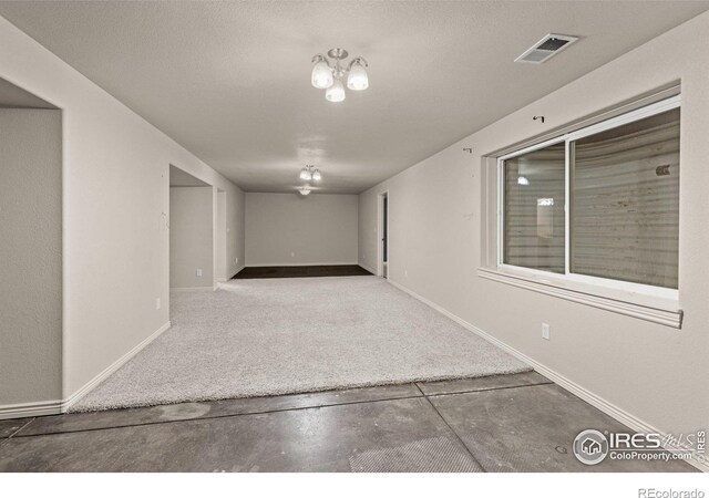 7548 County Road 100, Wellington, CO 80549 - spare room featuring baseboards, carpet flooring, and concrete flooring