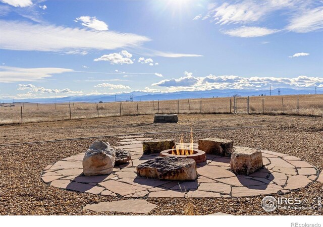 7548 County Road 100, Wellington, CO 80549 - view of patio with an outdoor fire pit, fence, and a rural view