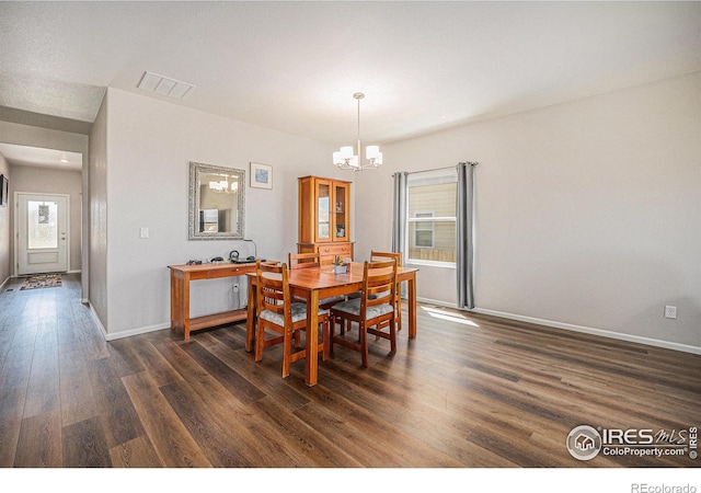 dining room with an inviting chandelier, baseboards, dark wood-type flooring, and visible vents