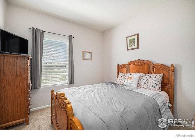 carpeted bedroom with baseboards