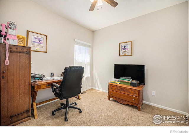 carpeted office space with baseboards and ceiling fan