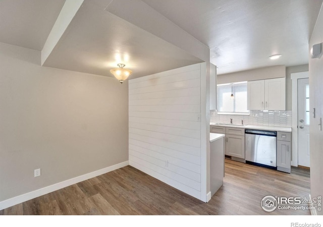 221 Chestnut St, Windsor, CO 80550 - kitchen featuring dishwasher, light wood finished floors, light countertops, and decorative backsplash