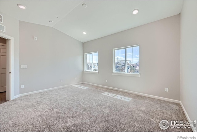 empty room with visible vents, baseboards, lofted ceiling, carpet, and recessed lighting