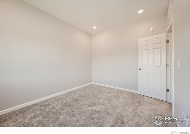 empty room featuring baseboards, carpet flooring, and recessed lighting