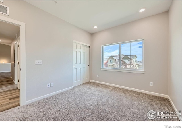 unfurnished bedroom featuring carpet flooring, recessed lighting, baseboards, and visible vents