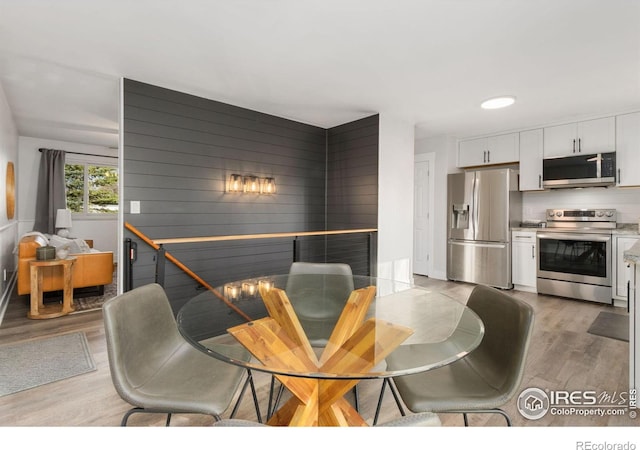 2139 Donna Ct, Loveland, CO 80537 - dining space with wood walls and light wood finished floors