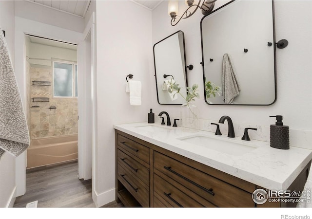 2139 Donna Ct, Loveland, CO 80537 - bathroom with double vanity, a sink, shower / tub combination, and wood finished floors