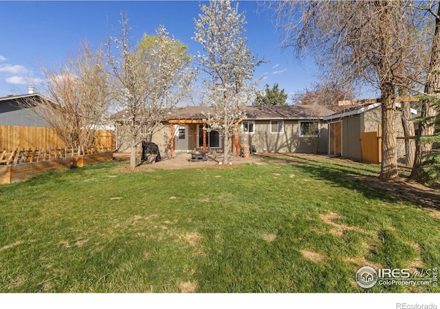 2139 Donna Ct, Loveland, CO 80537 - back of house with an outdoor structure, fence, a yard, and a shed