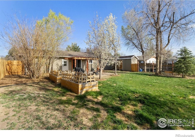 2139 Donna Ct, Loveland, CO 80537 - view of yard featuring a fenced backyard and a garden